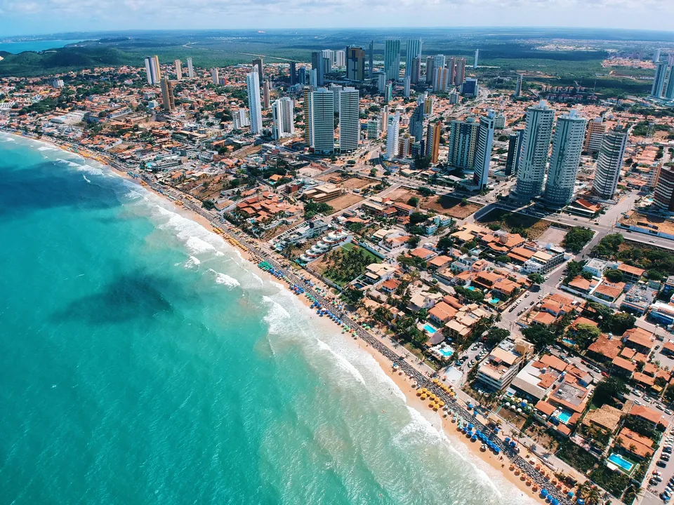 Aerial view of a Brazilian coastal city and turquoise shoreline