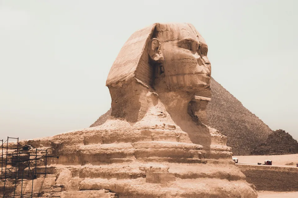 The Sphinx with a pyramid in the background