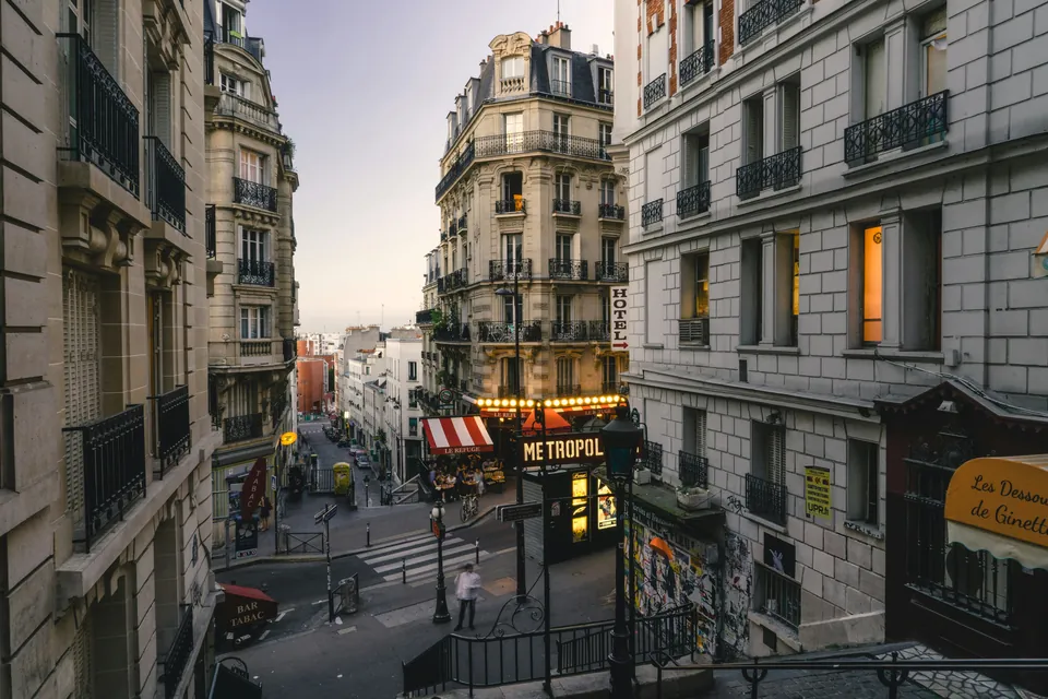 Paris street with buildings, shops and pedestrians