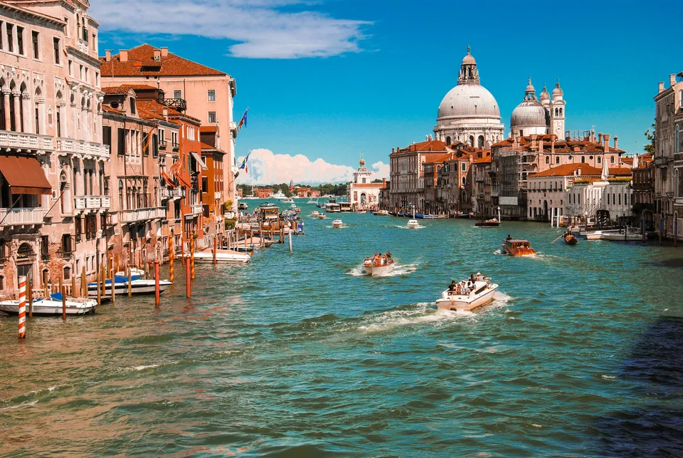 Boats on a canal lined with historic buildings in Venice