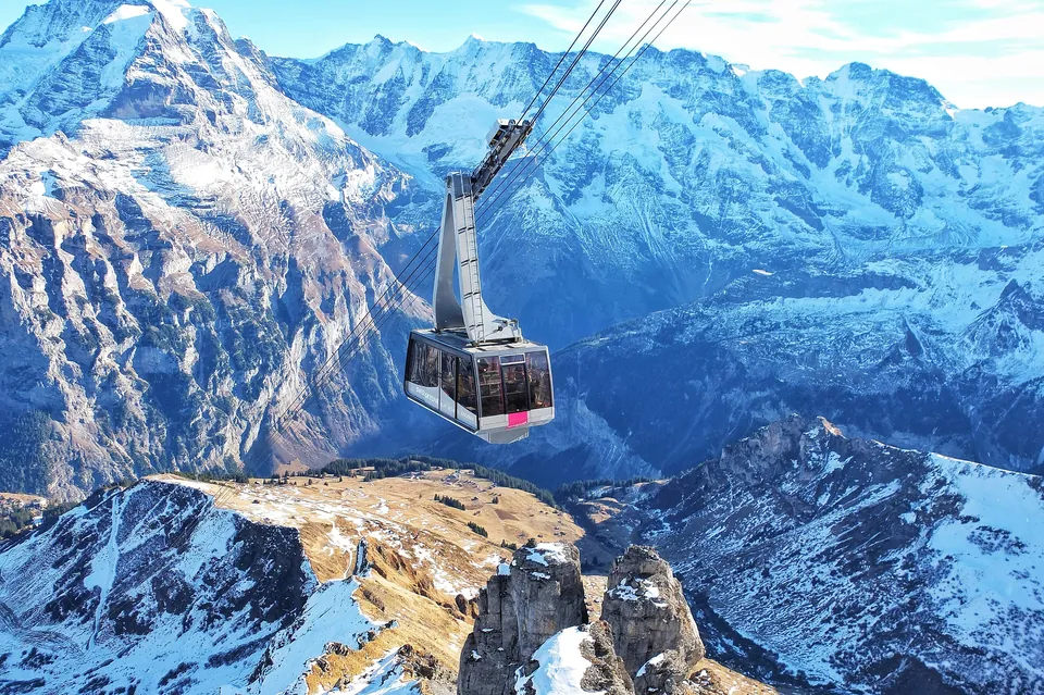 Cable car above a snow-covered Alpine mountain range