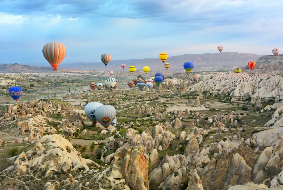 Hot-air balloons above rocky valleys in Cappadocia